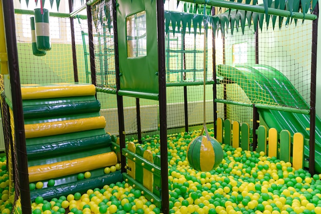 A play area with a ball and a green ball.
