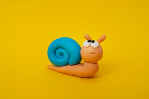 Play dough yellow background with snail