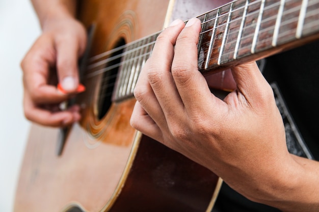 Play the guitar by hand, close up.