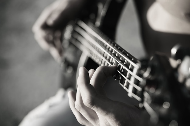 Play the guitar. Live music background. Music festival. Instrument on stage and band. Music concept. Electric guitar. Black and white.