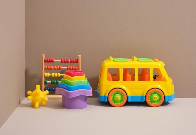 Photo play time and kids toys composition a brightly colored car sand toys and an abacus