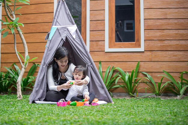 Play toys with mother in tent