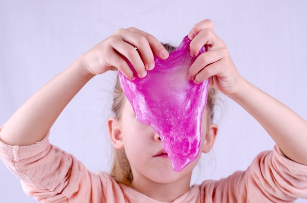 Play with a kid while staying at home quarantine, make slime by yourself. Toy Slime in a kids hand. Worldwide popular self-made toy.