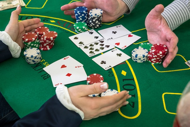 Player and dealer, raking pile of chips