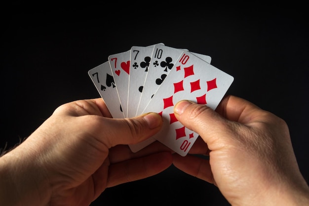 The player hands hold playing cards with a winning combination of full house or full boat