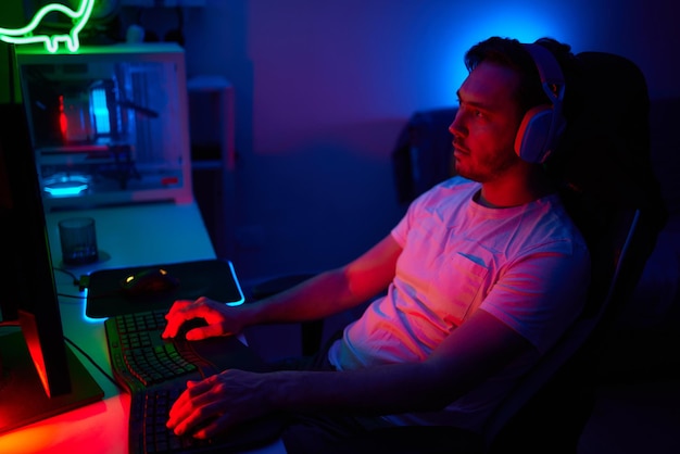 Photo player looking at his computer screen contemplating his next move in an online video game