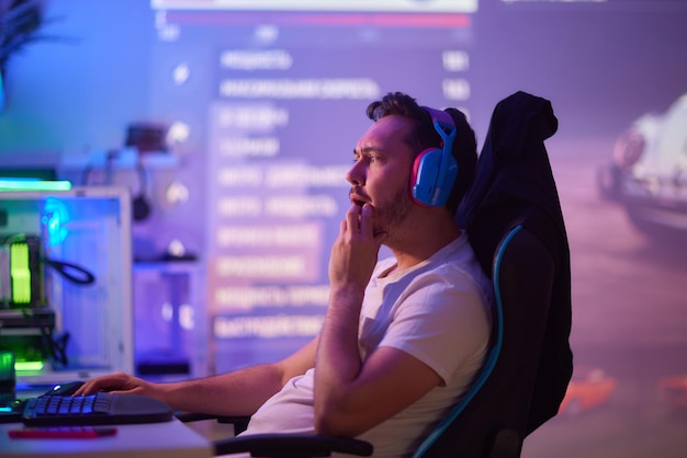 Player looking at his computer screen contemplating his next move in an online video game