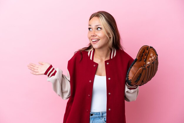 Player Russian woman with baseball glove isolated on pink background with surprise expression while looking side