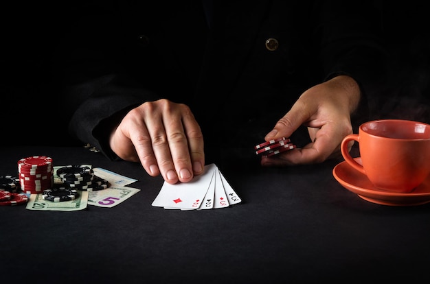 Photo the player shows cards with a winning combination of two pairs in a poker club