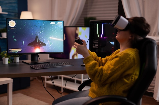 Player woman wearing virtual reality goggles while playing\
space shooter videogames for online game competition on computer\
usimg gaming joystick. streamer player doing entertainment\
activities