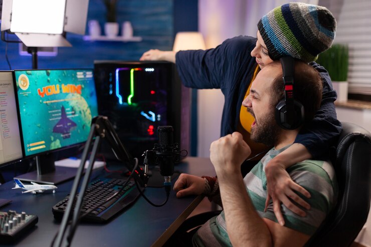 Photo players couple winning online videogames competition using professional equipment in home studio. gamer playing video games with new graphics on powerful gaming computer with rgb