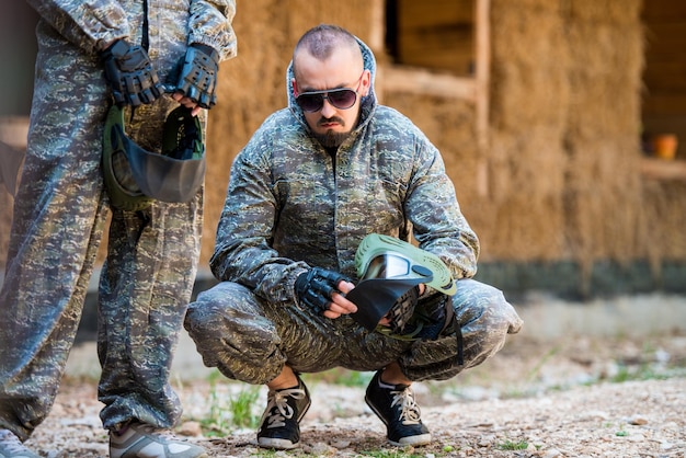 Players in paintball prepare for fight