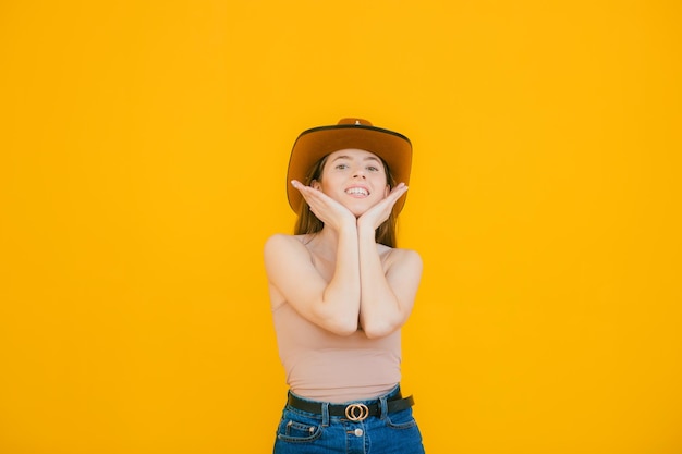 Playful beauty in country style beautiful young woman in cowboy hat