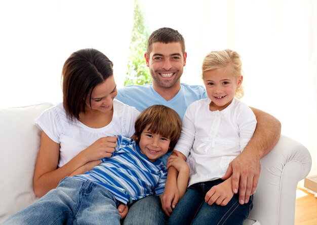 Playful family sitting on sofa at home