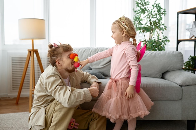 Playful father and daughter enjoy game together