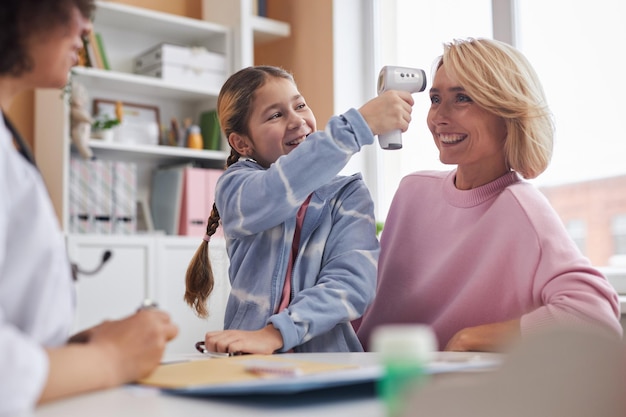 Playful girl having fun at doctors office