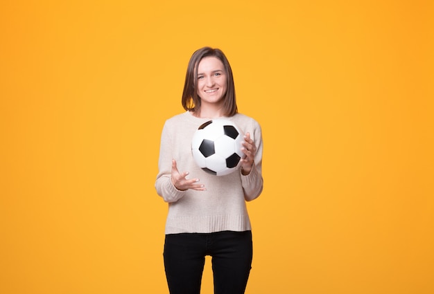 Playful girl is holding a ball.