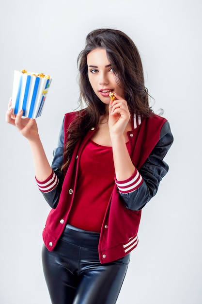 Playful girl with pack of popcorn