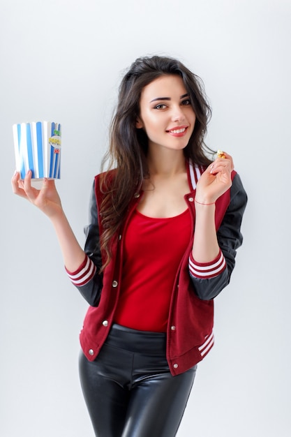 Playful girl with pack of popcorn