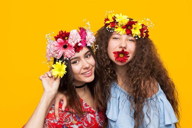 Playful girls posing with flowers