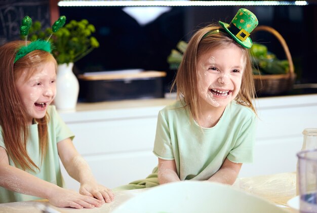 Playful kids playing with the flour