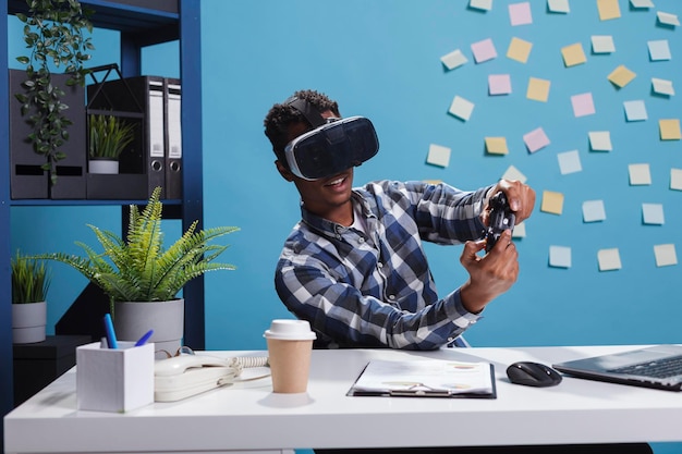 Photo playful office person wearing virtual reality technology headset while using modern controller to casually play video games at work. finance department team leader enjoying playing on console.