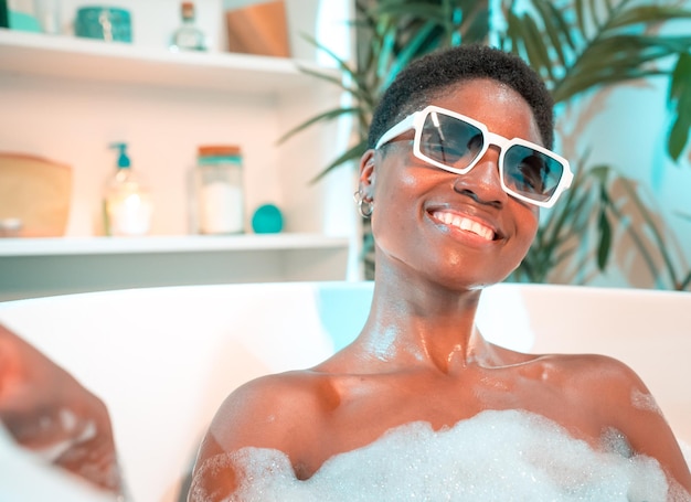 Playful woman smiling and looking to camera while enjoying bubble bath in holiday vacation