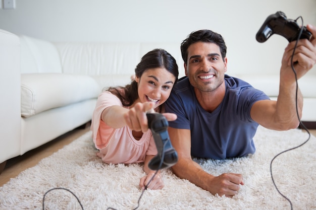 Playful young couple playing video games