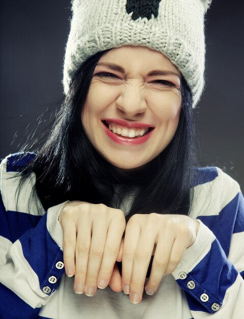 Playful young woman in funny winter hat