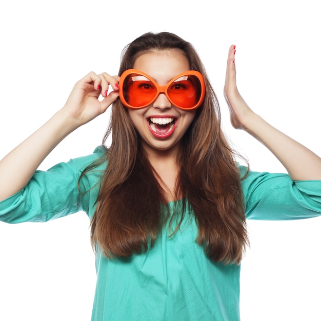  Playful young woman with party glasses. Ready for good time.