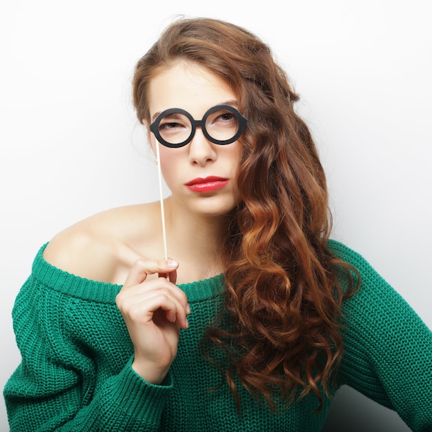 Playful young women holding party glasses