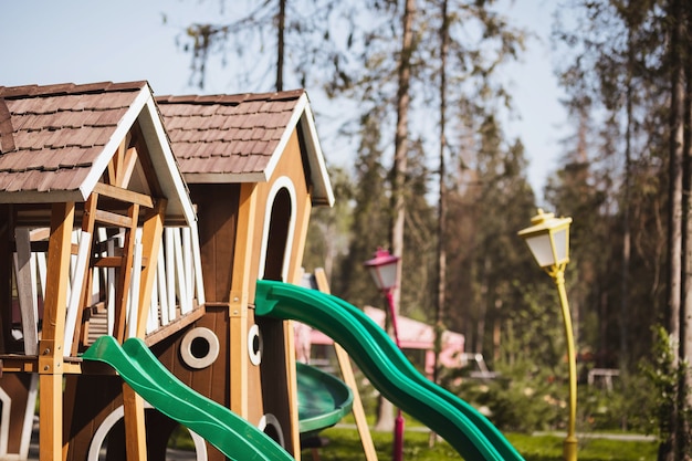playground in the forest with houses slides and lanterns