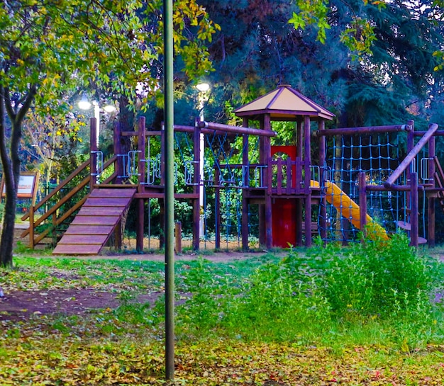 Playground between trees in the evening