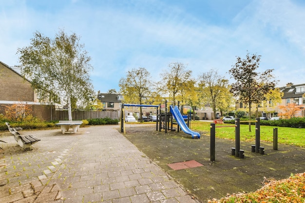 A playground with a blue slide in a park