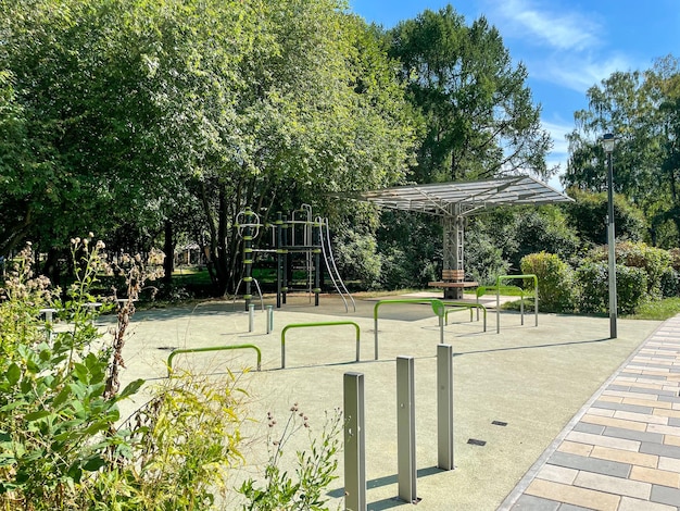 A playground with a swing set and a tree in the background