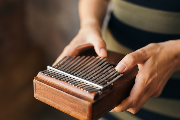 Playing on the African instrument Kalimba or Mbira Traditional instrument from Africa close up