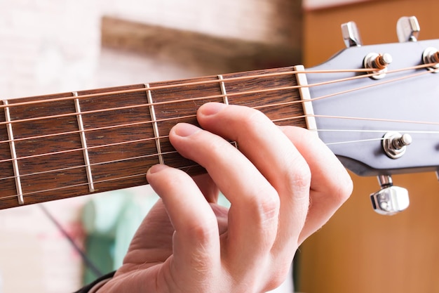 Playing black guitar guitar hands close up