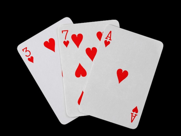 Playing cards 3 7 and ace are fanned out isolated on a black background