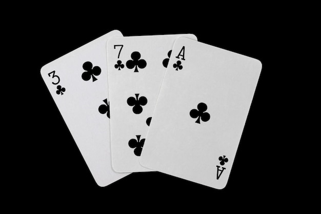 Playing cards 3 7 and ace are fanned out isolated on a black background