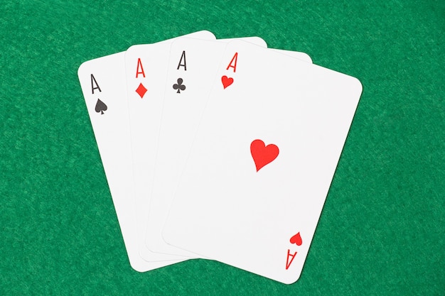 Playing cards - four aces on green table