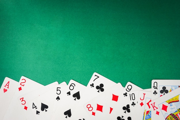 Photo playing cards on green background. free space for text