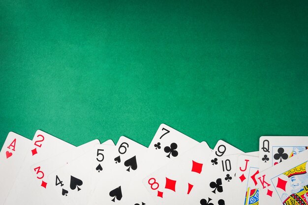 Photo playing cards on green background free space for text