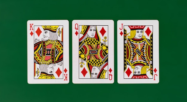 Playing cards king queen jack with plain green background\
casino poker