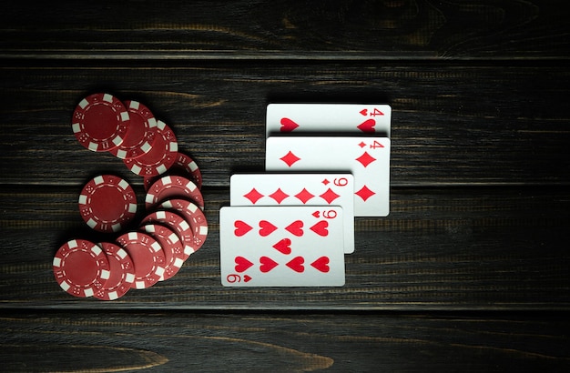 Playing cards with a winning combination two pairs on a black table in a poker club