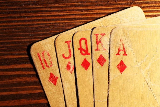 Playing cards on wooden table closeup