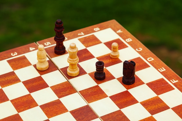 Playing chess on a Board on the beach. Vacation on the coast.