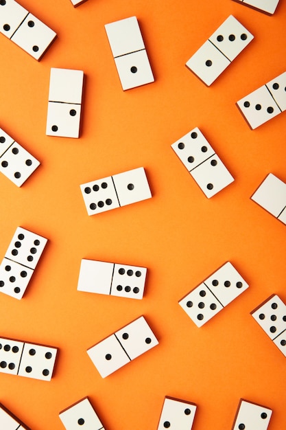 Playing dominoes on a orange table