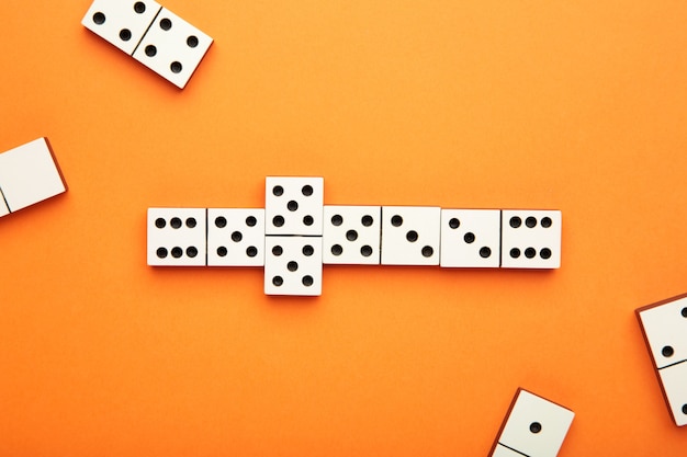 Playing dominoes on a orange table