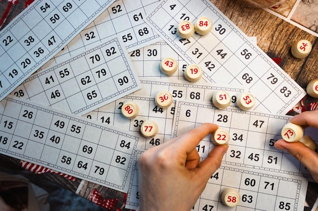 playing lotto game person holding cube with figure on bingo card background nostalgia lifestyle
