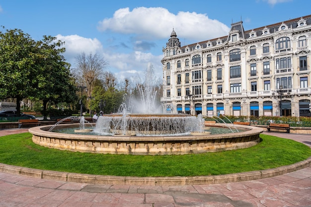 Plaza Escandalera with historic buildings and decorative fountain in the center of the square Oviedo Asturias